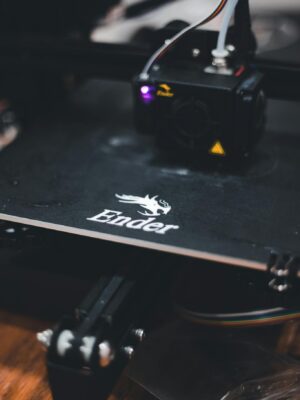 Detailed view of a 3D printer working on a design with the Ender brand logo visible.